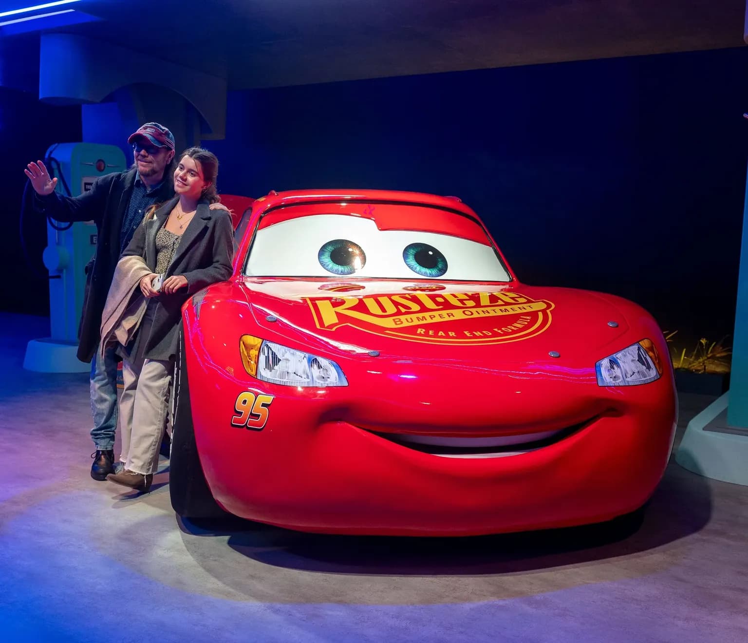 People standing by Lightning McQueen